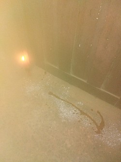 Charms spread on the floor with burning red candle by Bisola Abesin